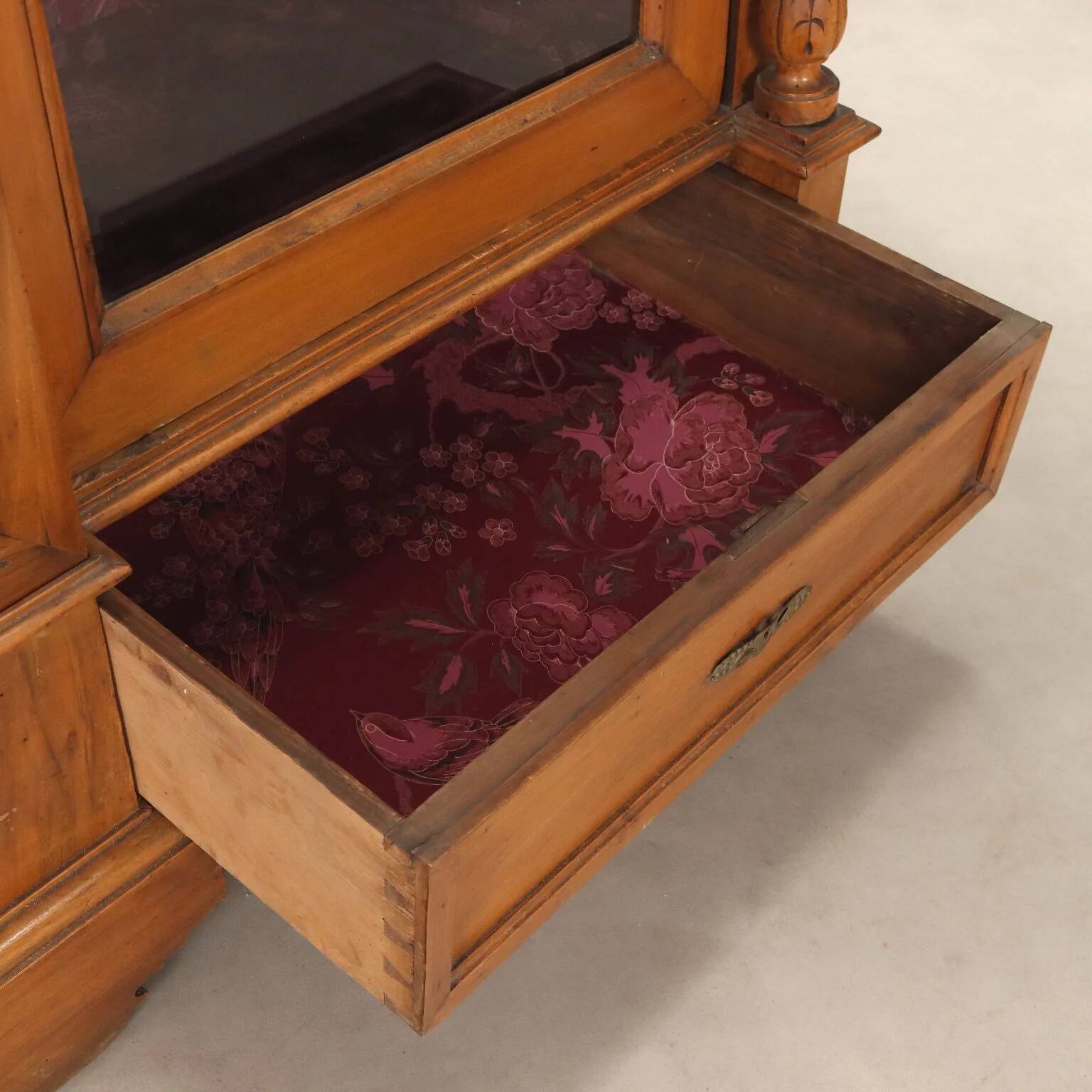 Antique walnut wardrobe with glass and carvings, Italy, 19th century.