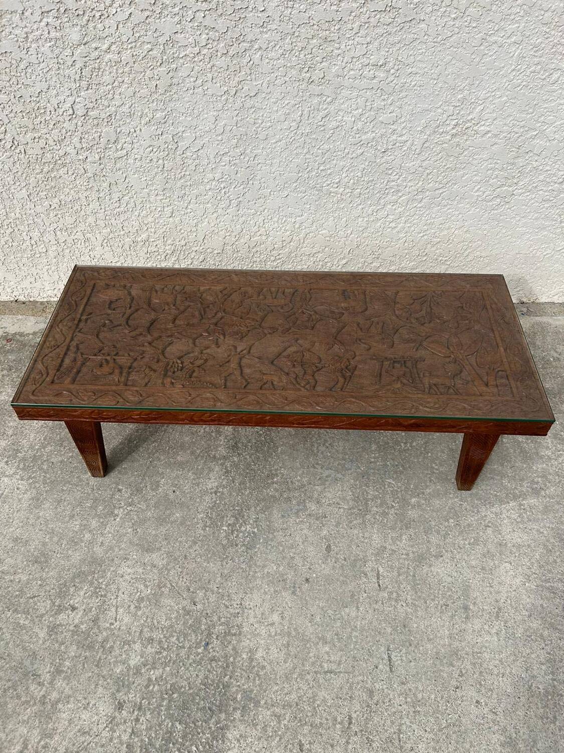 Afro style carved wooden table with glass top