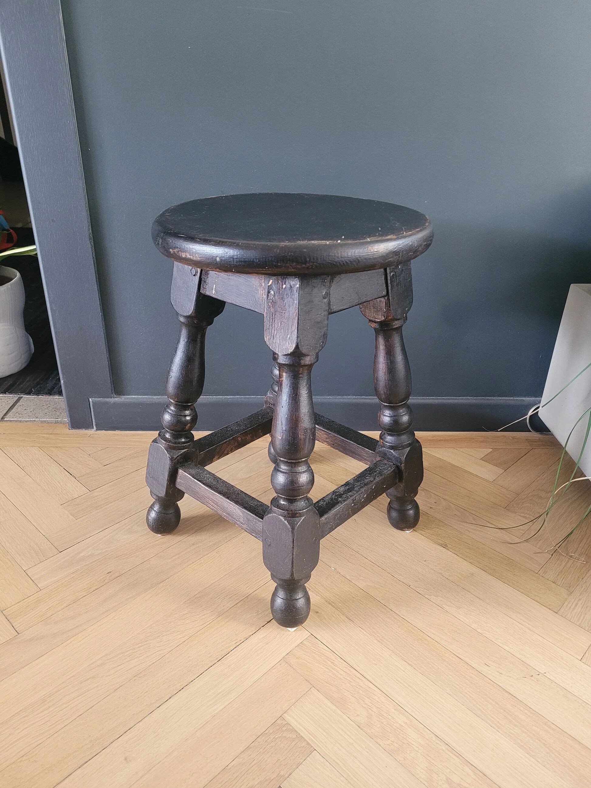 Antique wooden stool with turned legs.