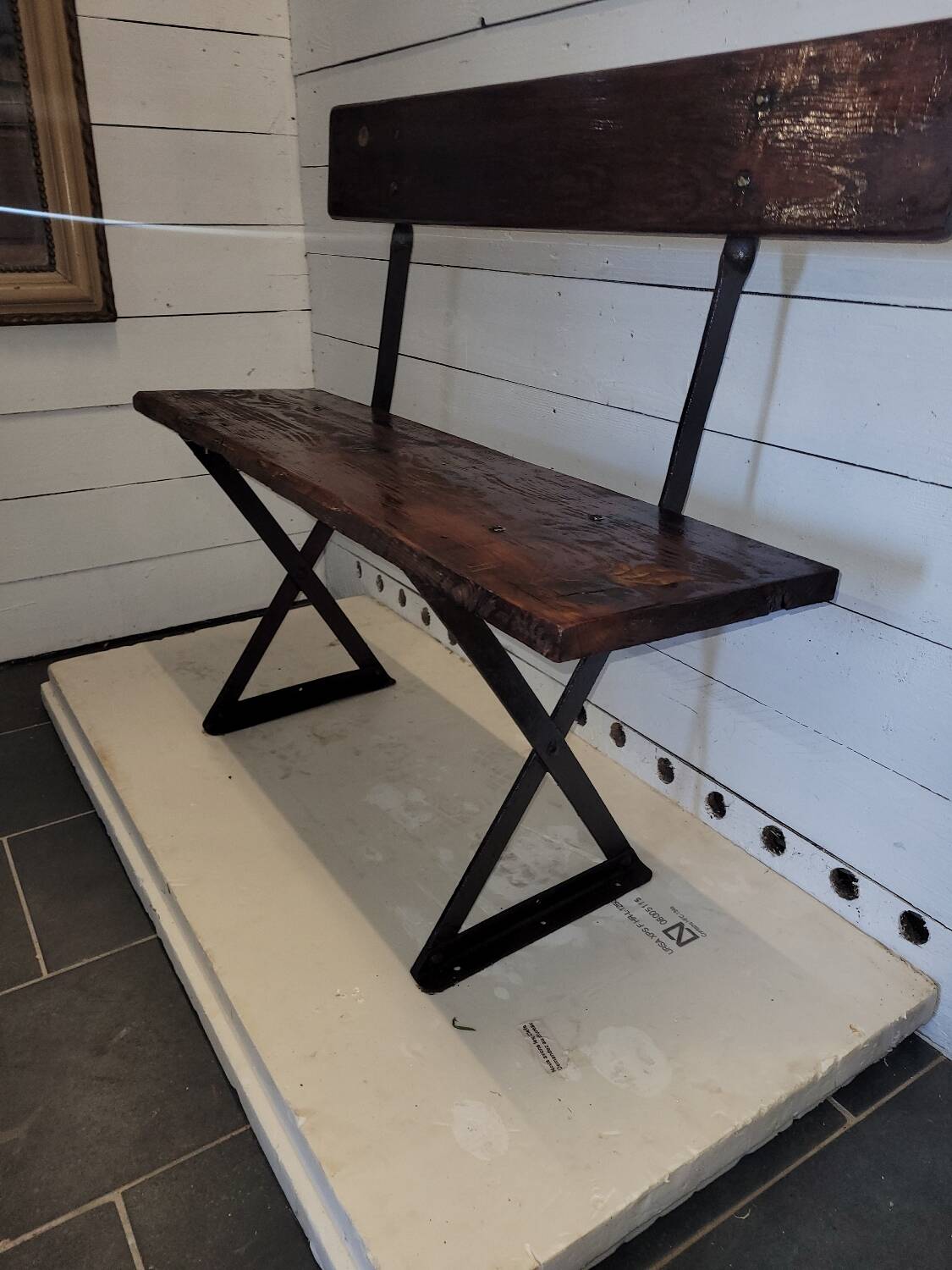Old garden bench with iron legs and wooden seats