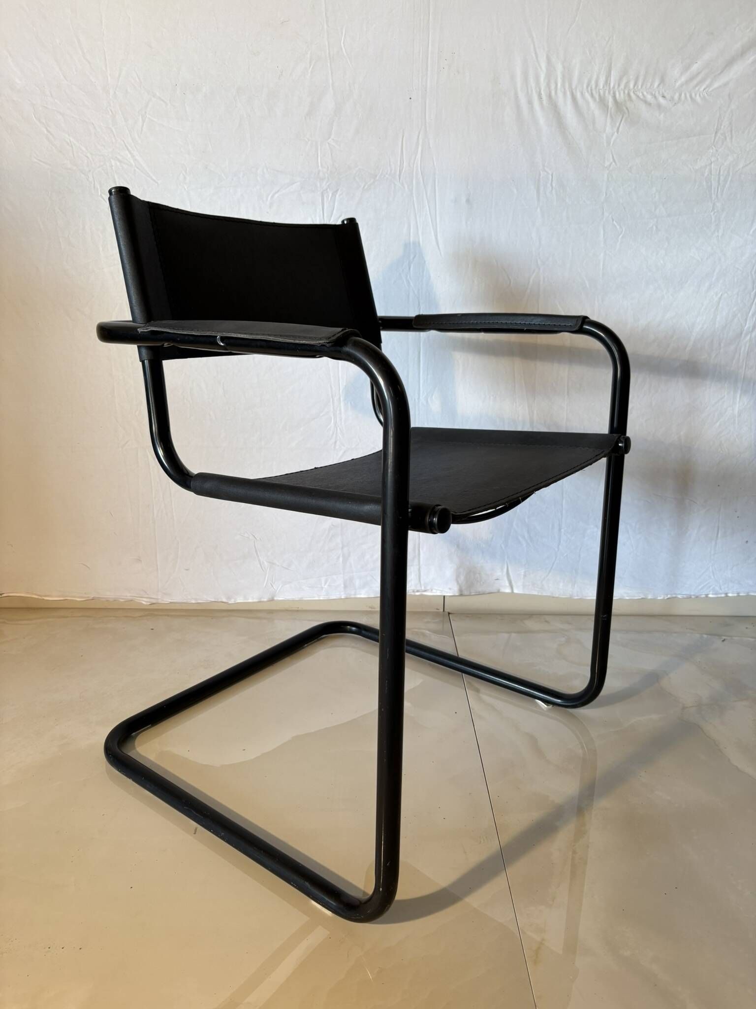 Set of 12 vintage black leather and tubular steel chairs – Italy, year