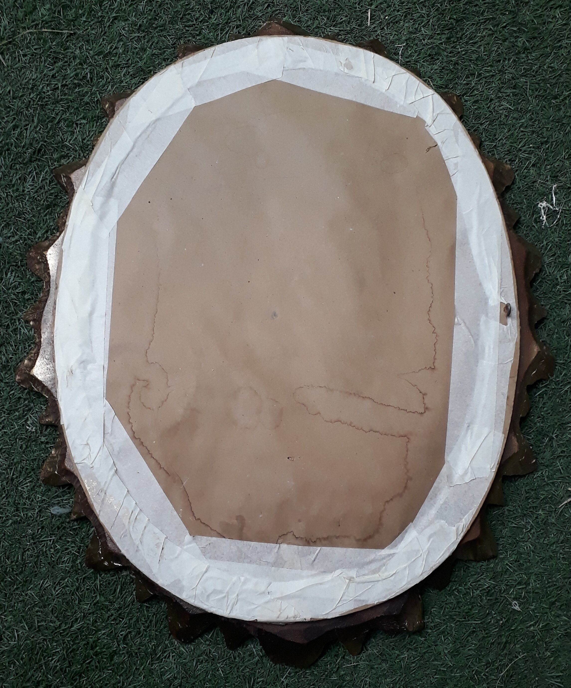 Oval sun mirror made of gilded solid wood