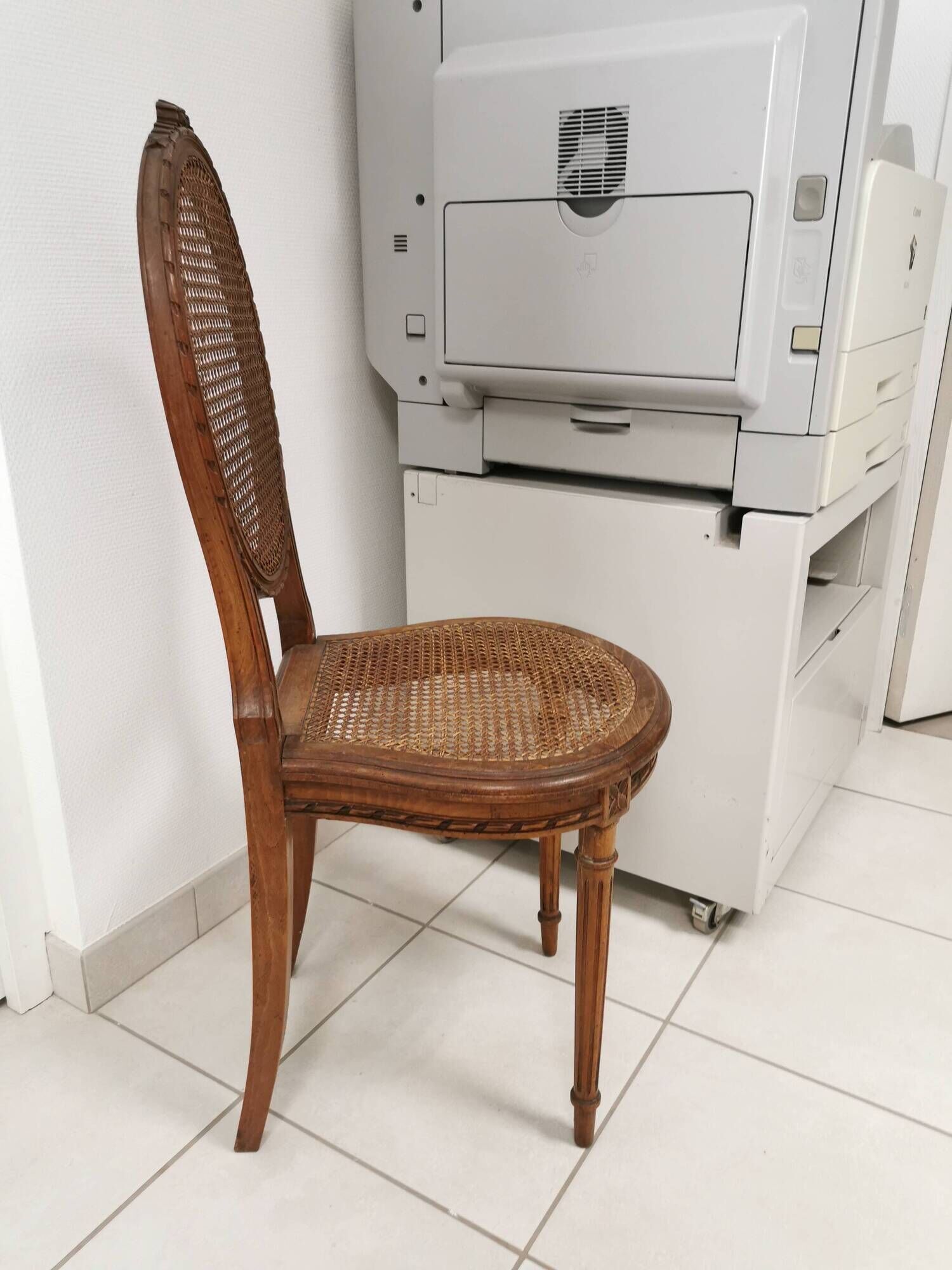 Antique chair Louis XVI style, seat caned, carved wood