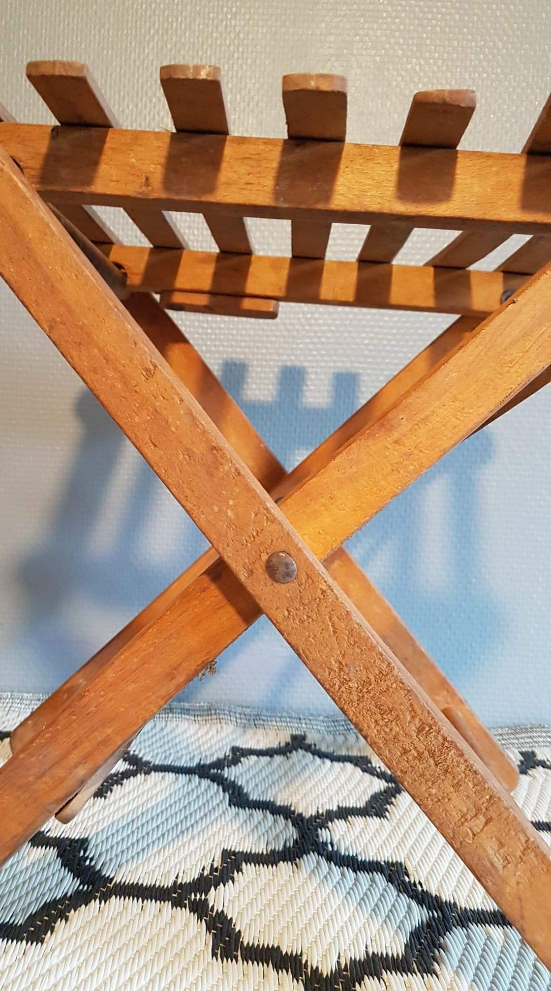 Old foldable stool in tinted wood