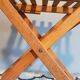Old foldable stool in tinted wood