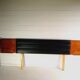 Mid century 1970s retro teak headboard with two hinged bedsides, upholstered in black by 'slumberlan