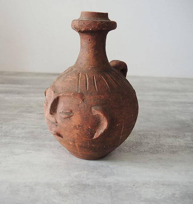 Old anthropomorphic terracotta vase pitcher