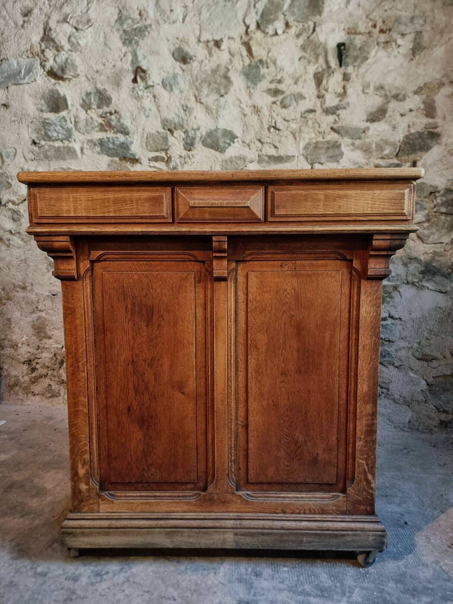 Antique French oak shop counter, kitchen island on wheels, circa 1880–1900.
