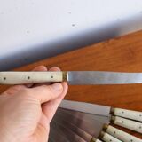 Set of 9 vintage cream table knives