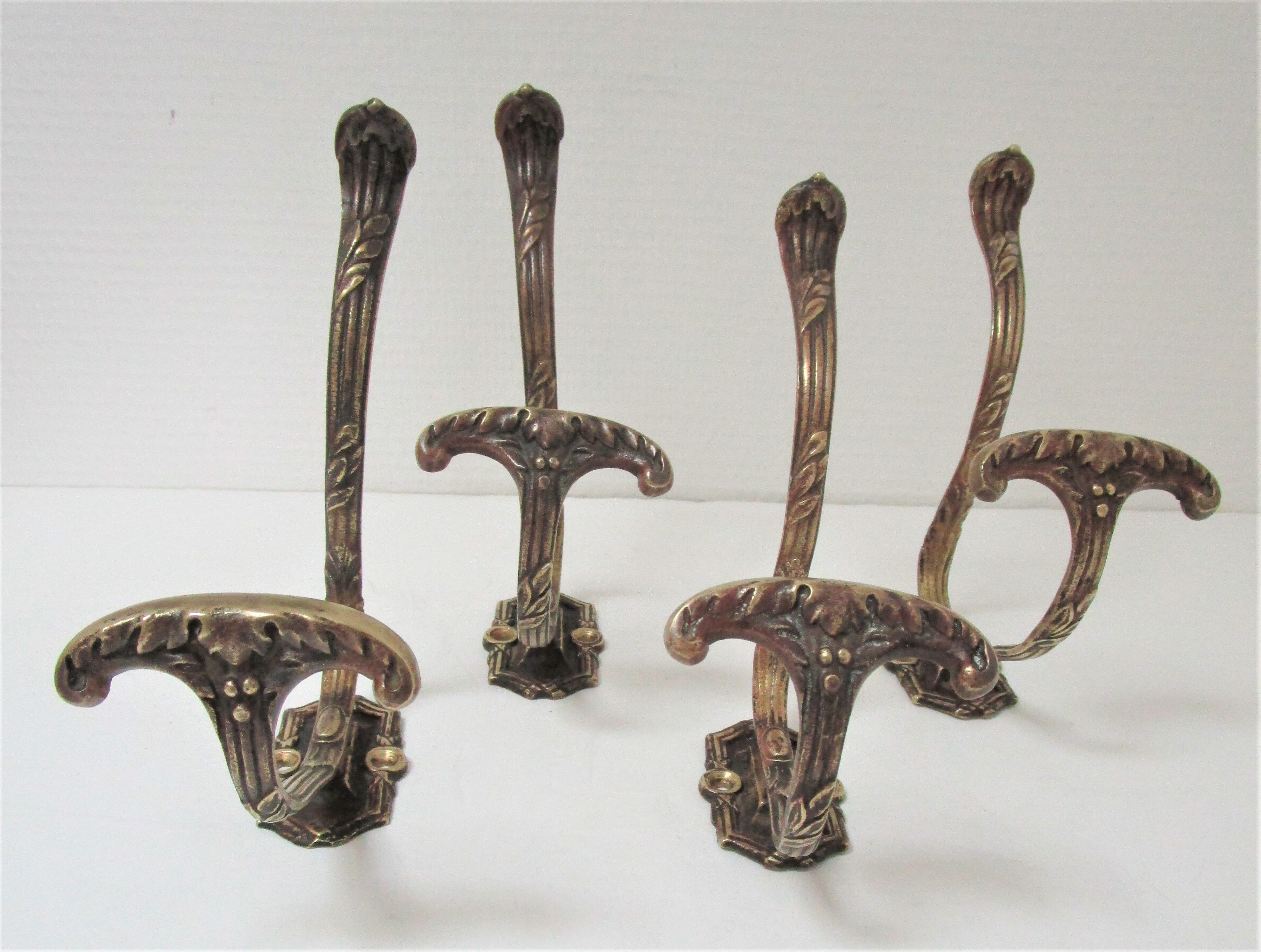 Four patères bronze patinated leafy décor early 20th century