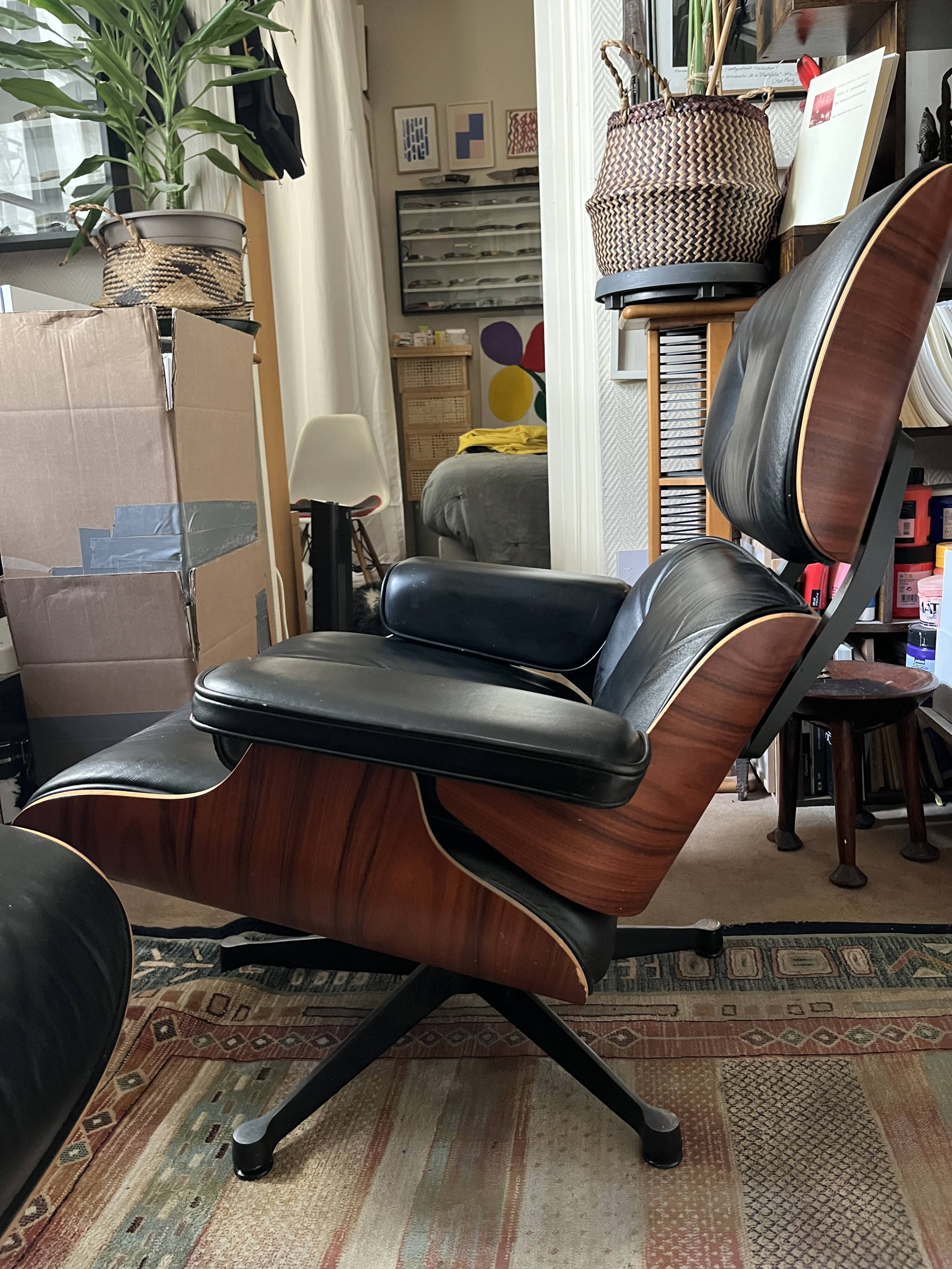 Black leather Eames Vitra armchair, original with rosewood ottoman.