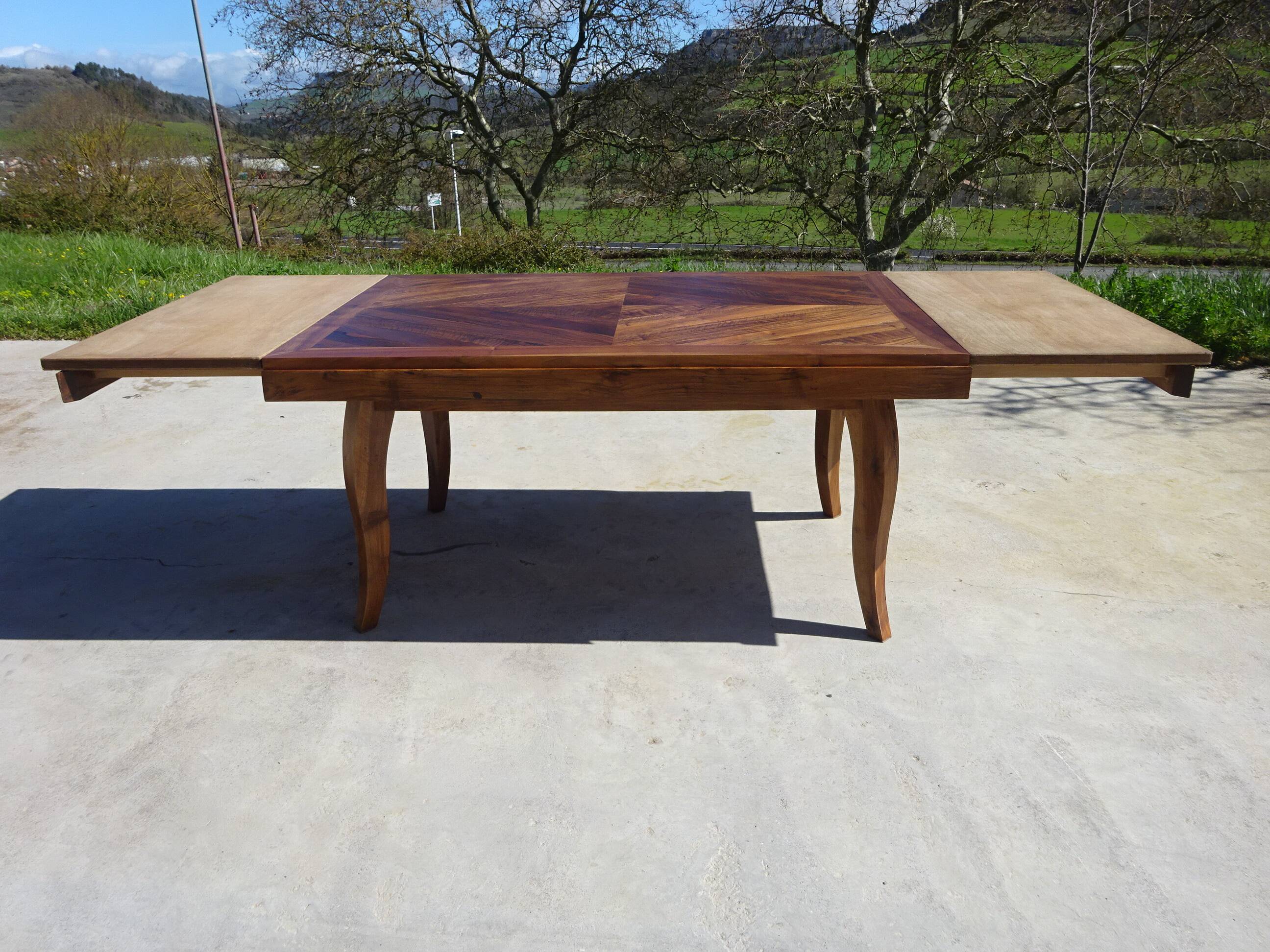 Antique solid walnut table with marquetry and extensions.