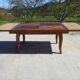 Antique solid walnut table with marquetry and extensions.