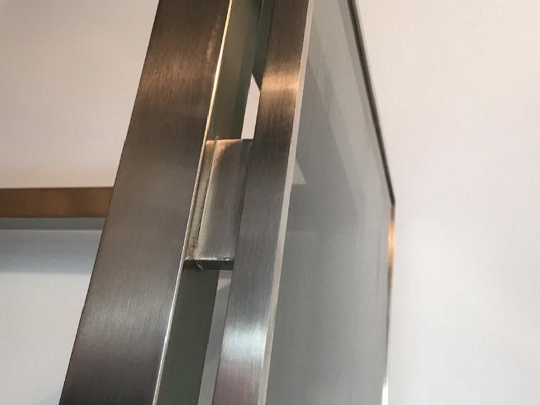 Beautiful console table in brushed metal with bluish glass shelves