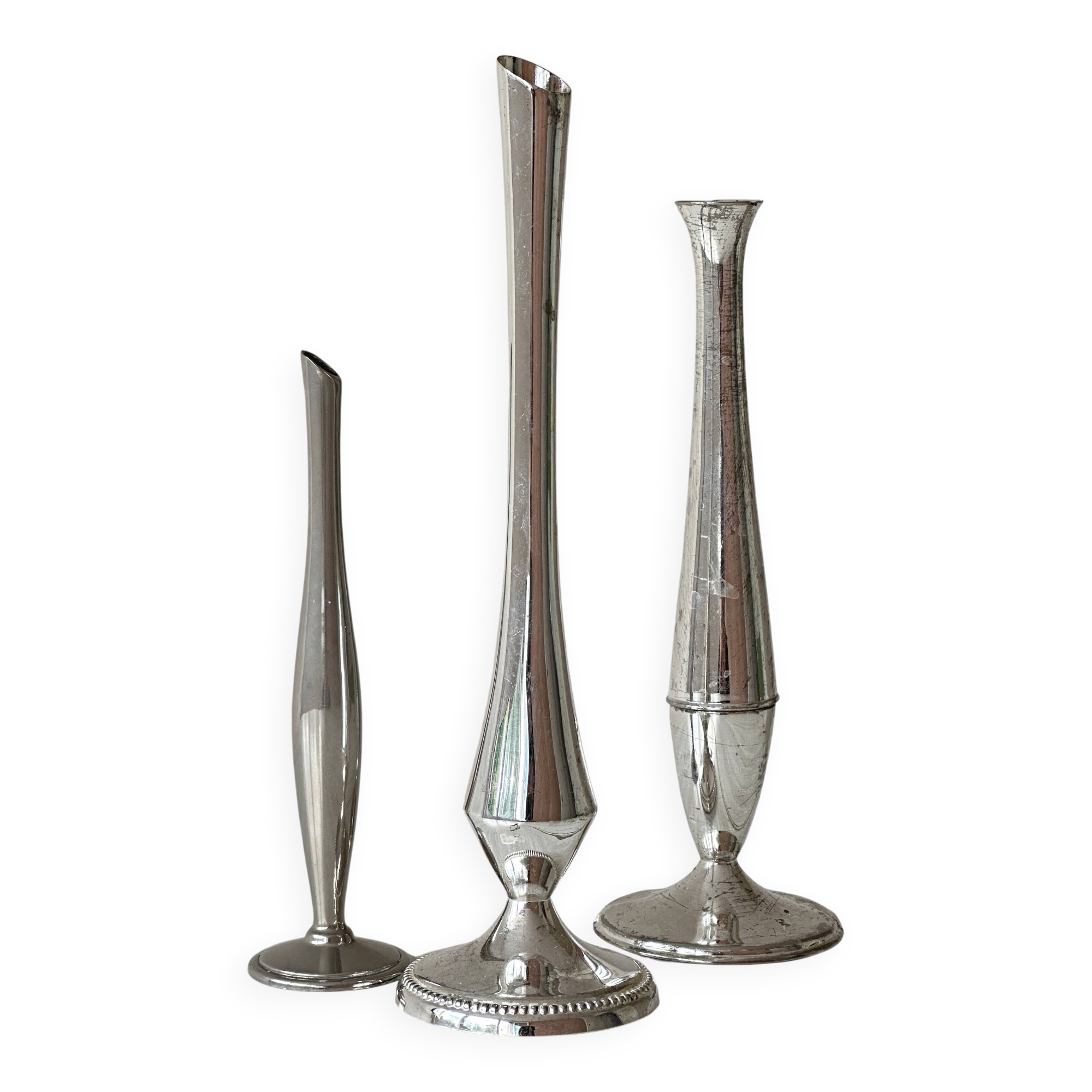 Set of three lightweight silver-coloured metal vases.