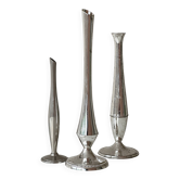 Set of three lightweight silver-coloured metal vases.