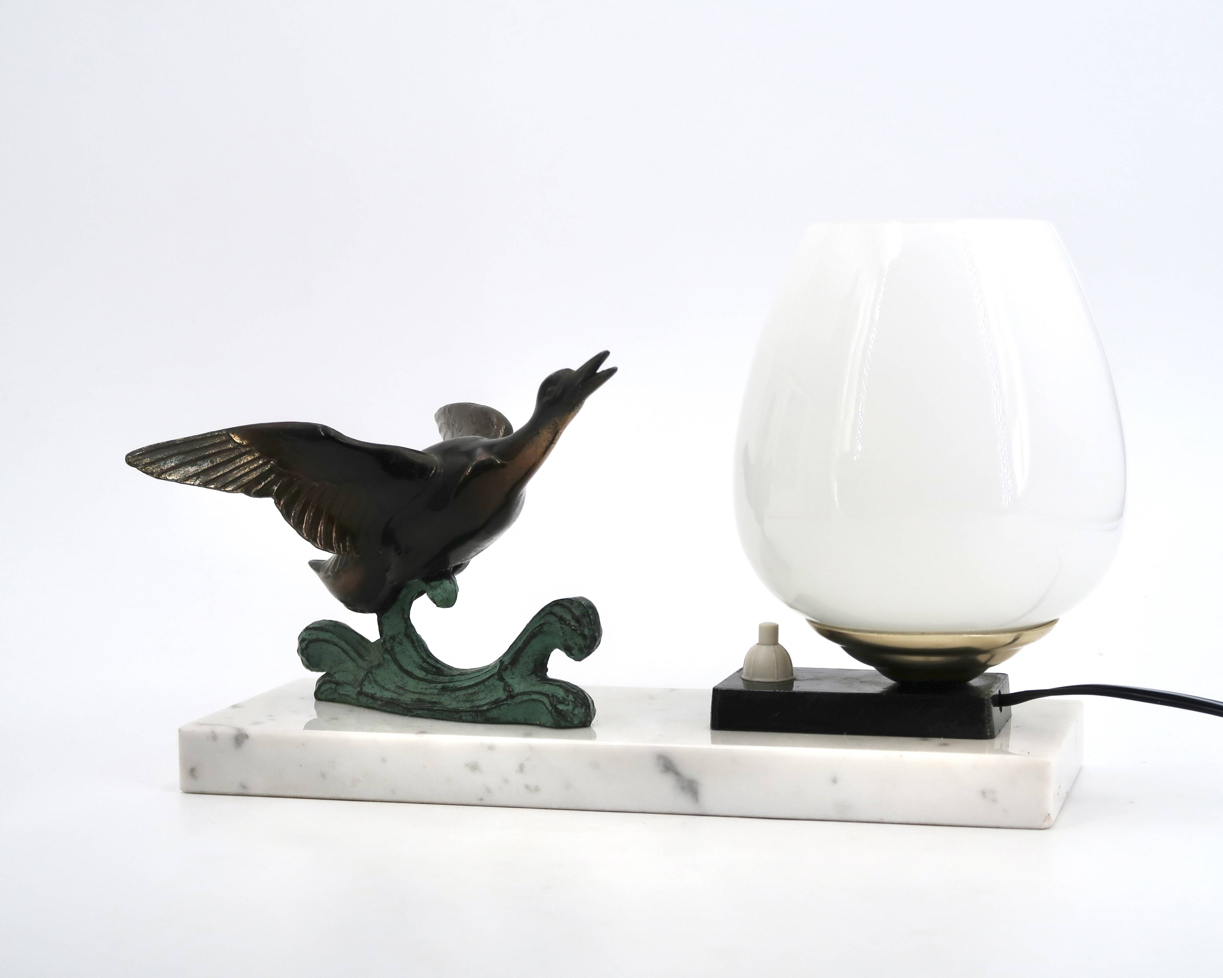 Art Deco lamp decorated with a flying duck, marble base, 1930s.
