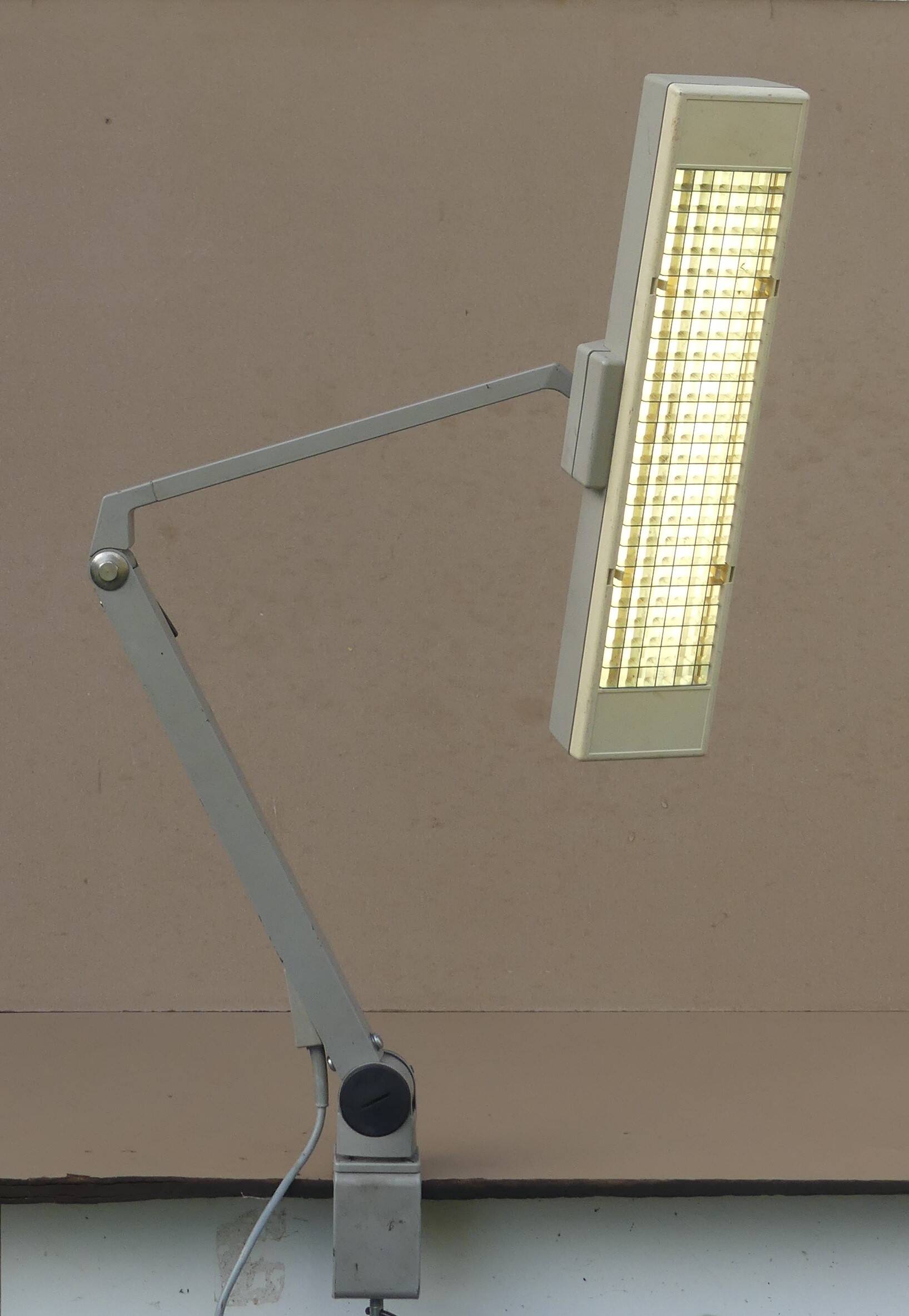 WALDMANN articulated workshop lamp with two industrial clamp arms for architects.