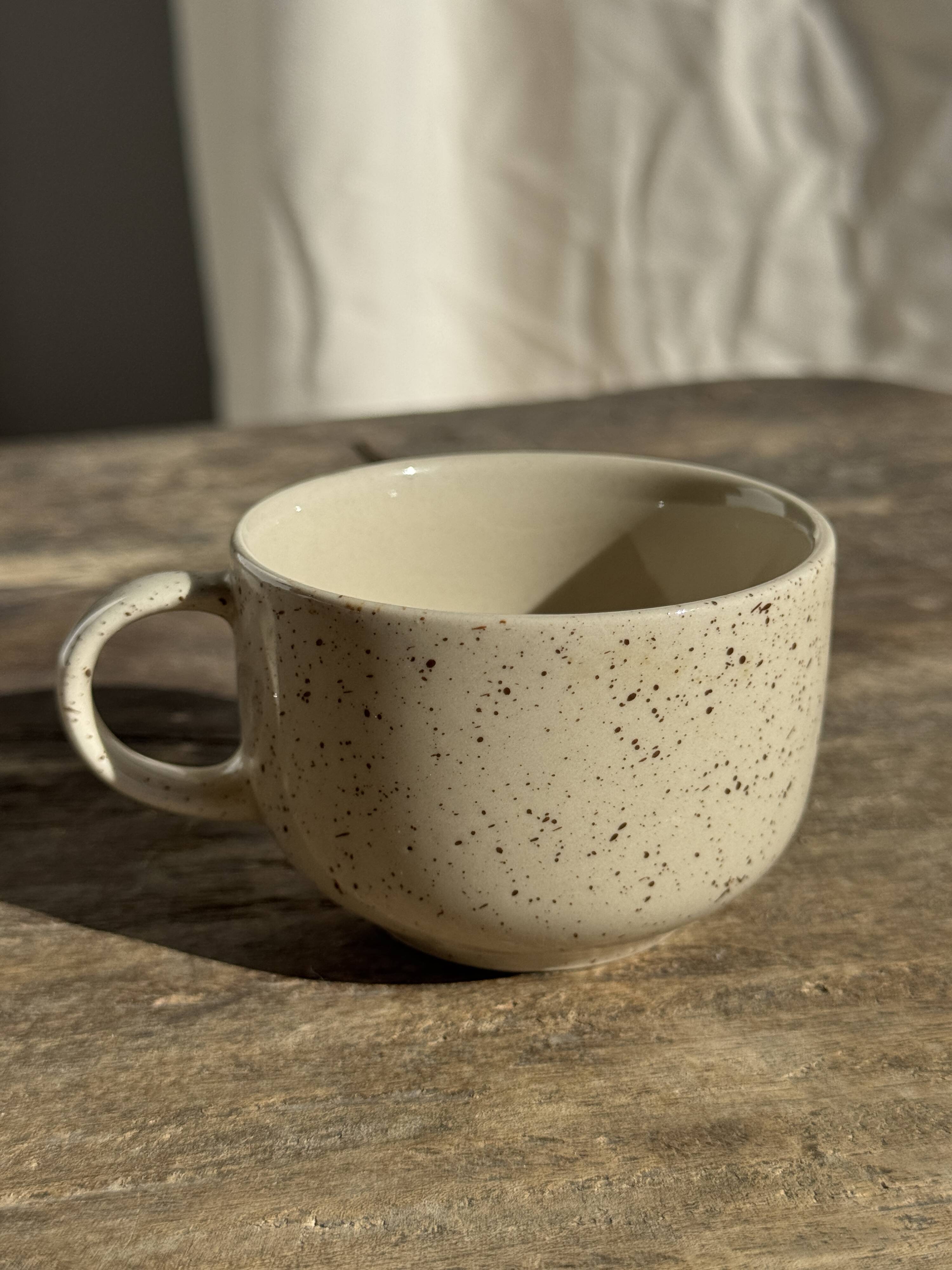 Set of 4 vintage speckled beige stoneware coffee cups.