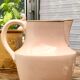 Antique pitcher in pink ceramic