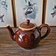 Vintage ceramic teapot (glazed earthenware) in brown colour.