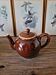 Vintage ceramic teapot (glazed earthenware) in brown colour.