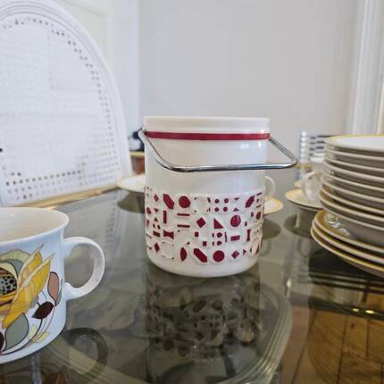 Vintage white opaline ice bucket with red patterns.
