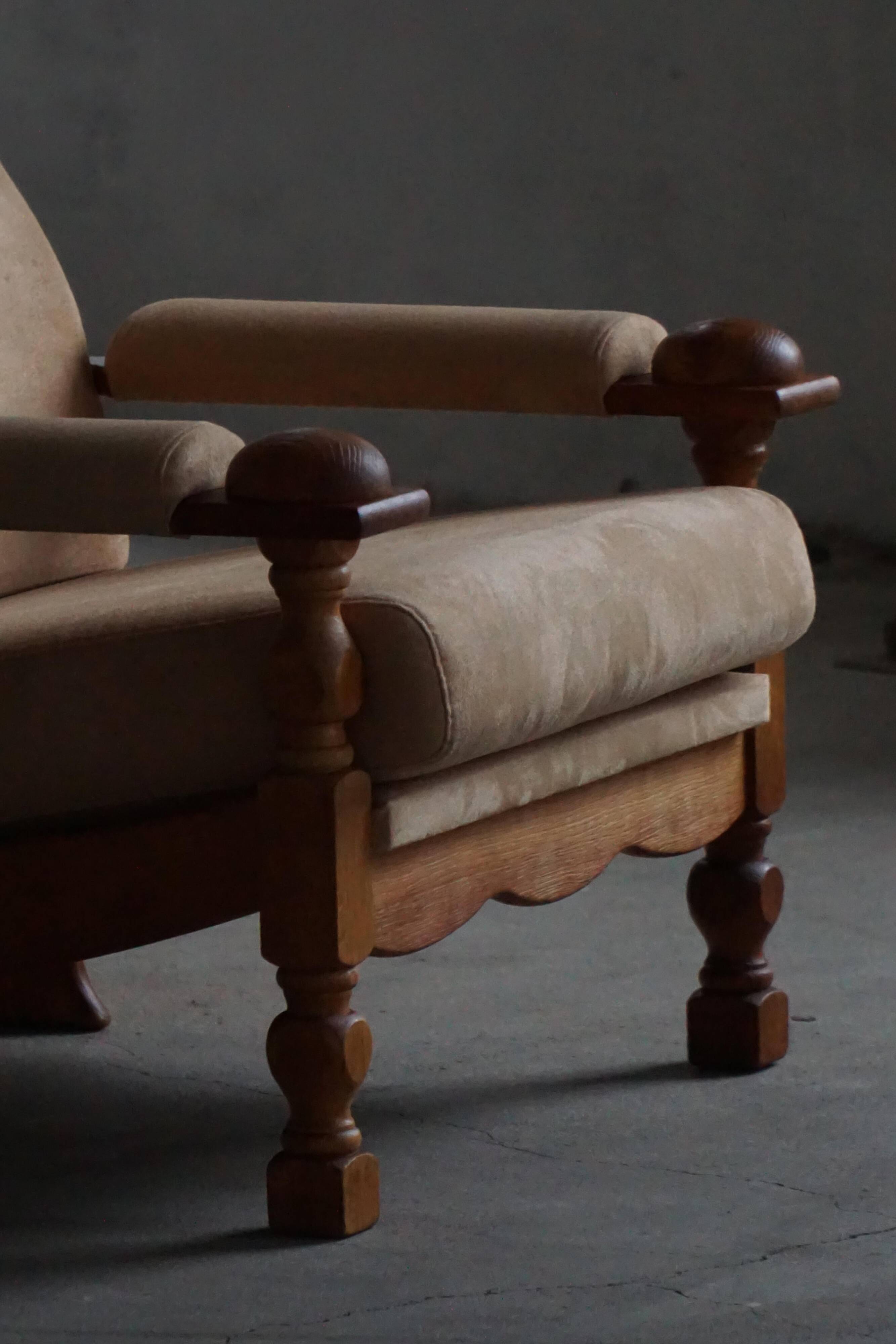 Mid-20th century, pair of armchairs by Henning Kjærnulf, oak and alcantara, 1960s.