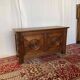 Small antique oak chest with carved panels.