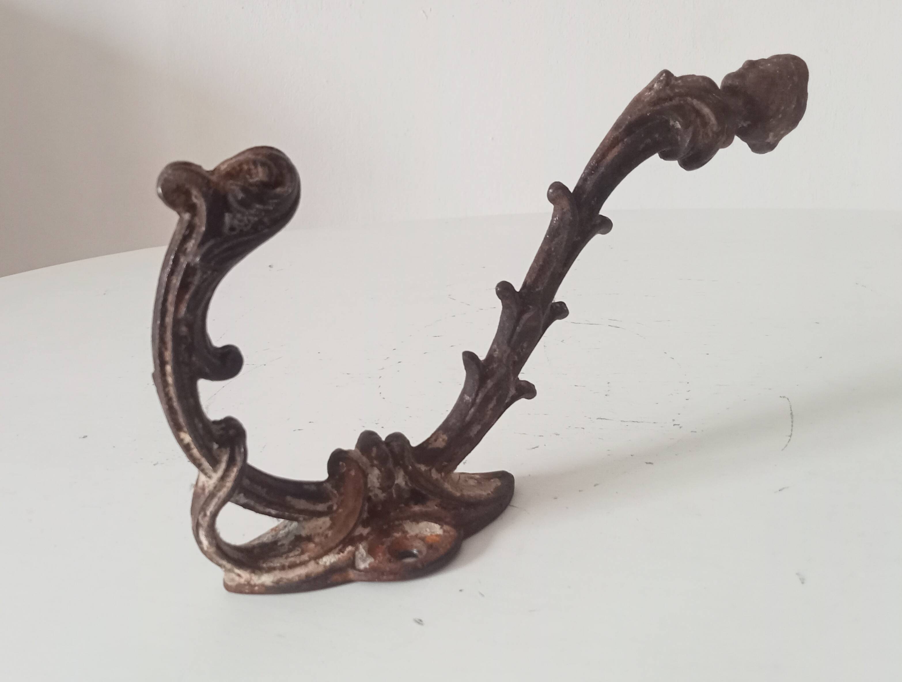 Antique wall coat hook from the 19th century in Victorian cast iron style.