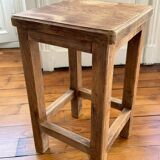 Brutalist stool in raw wood with a weathered effect.