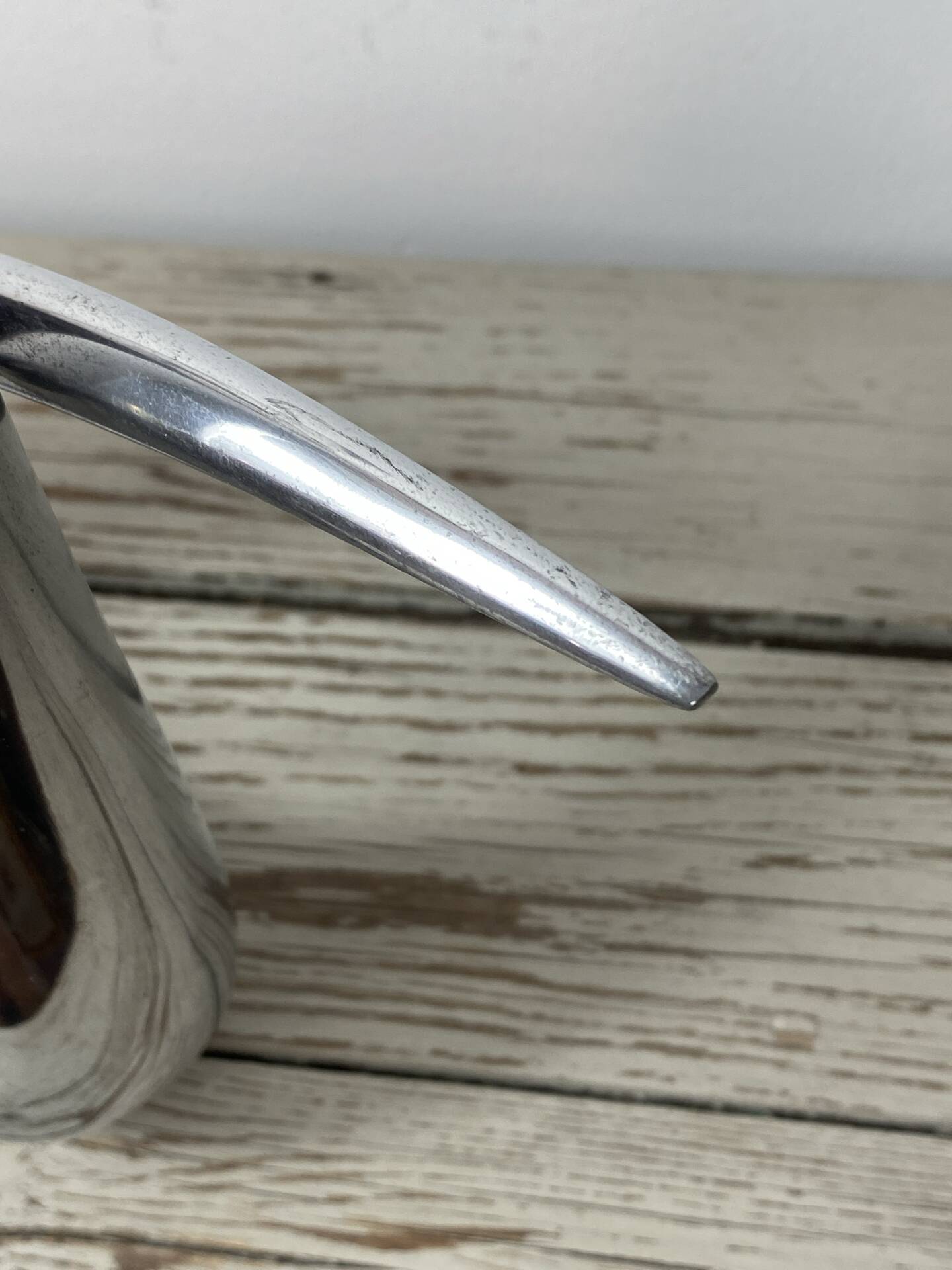 Sculptural vase design in polished aluminium.