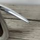 Sculptural vase design in polished aluminium.