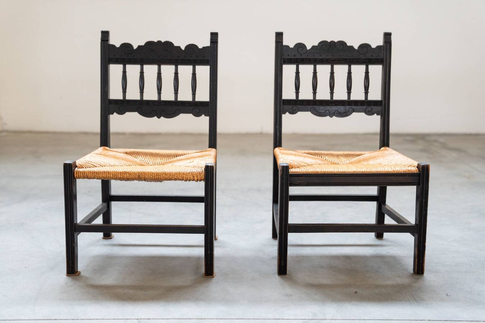 2 low bedroom chairs in hand-woven rice straw, 1950s/1960s