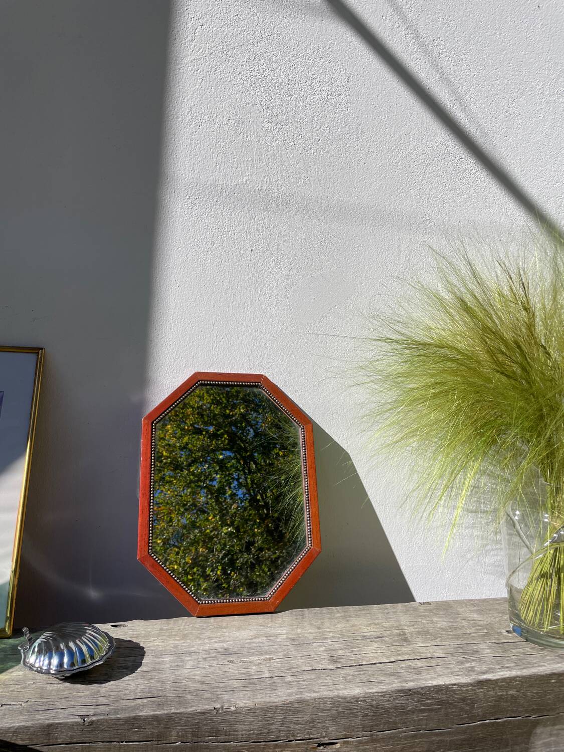 Octagonal beaded wooden mirror