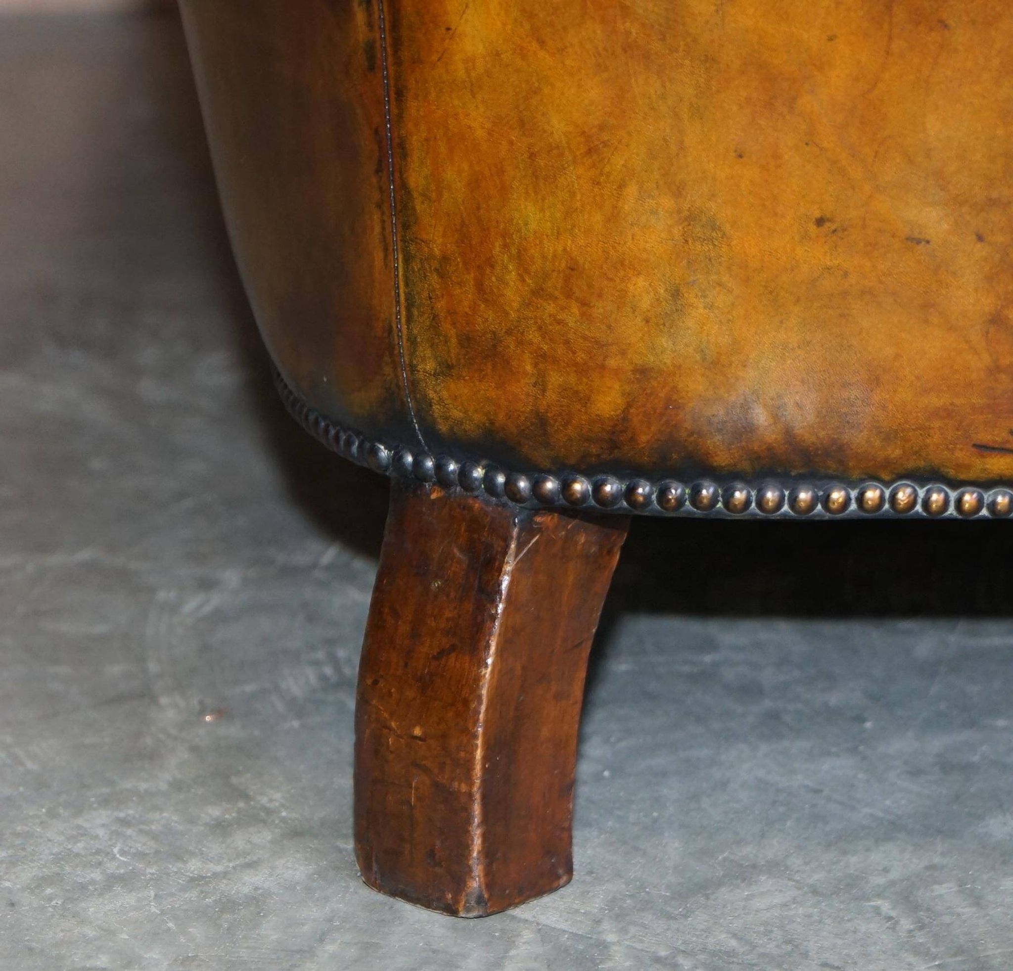 Victorian Chesterfield leather upholstered canapé with feather cushions.
