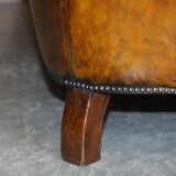 Victorian Chesterfield leather upholstered canapé with feather cushions.