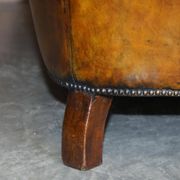 Victorian Chesterfield leather upholstered canapé with feather cushions.