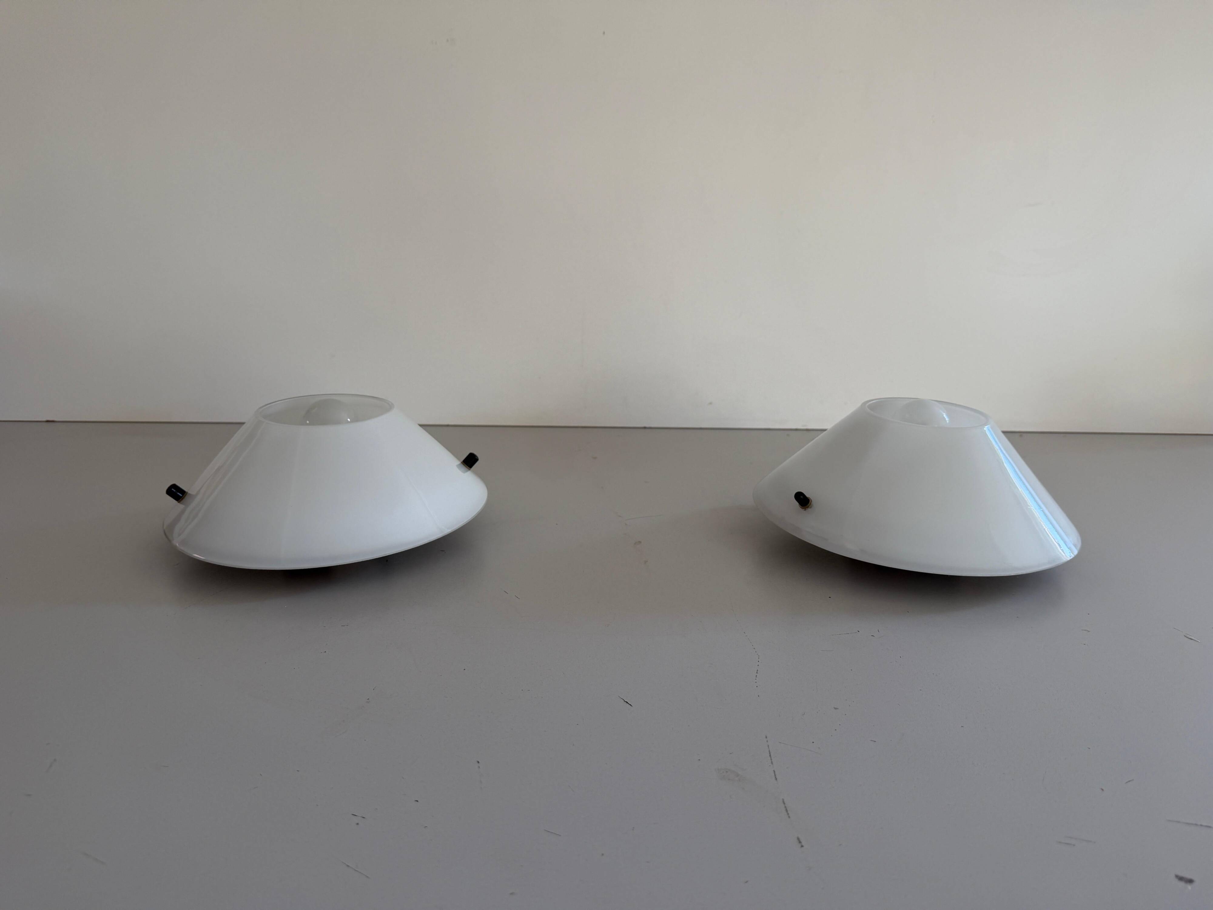Pair of opal glass wall lights from the mid-century by Lamperti, 1960s, Italy.
