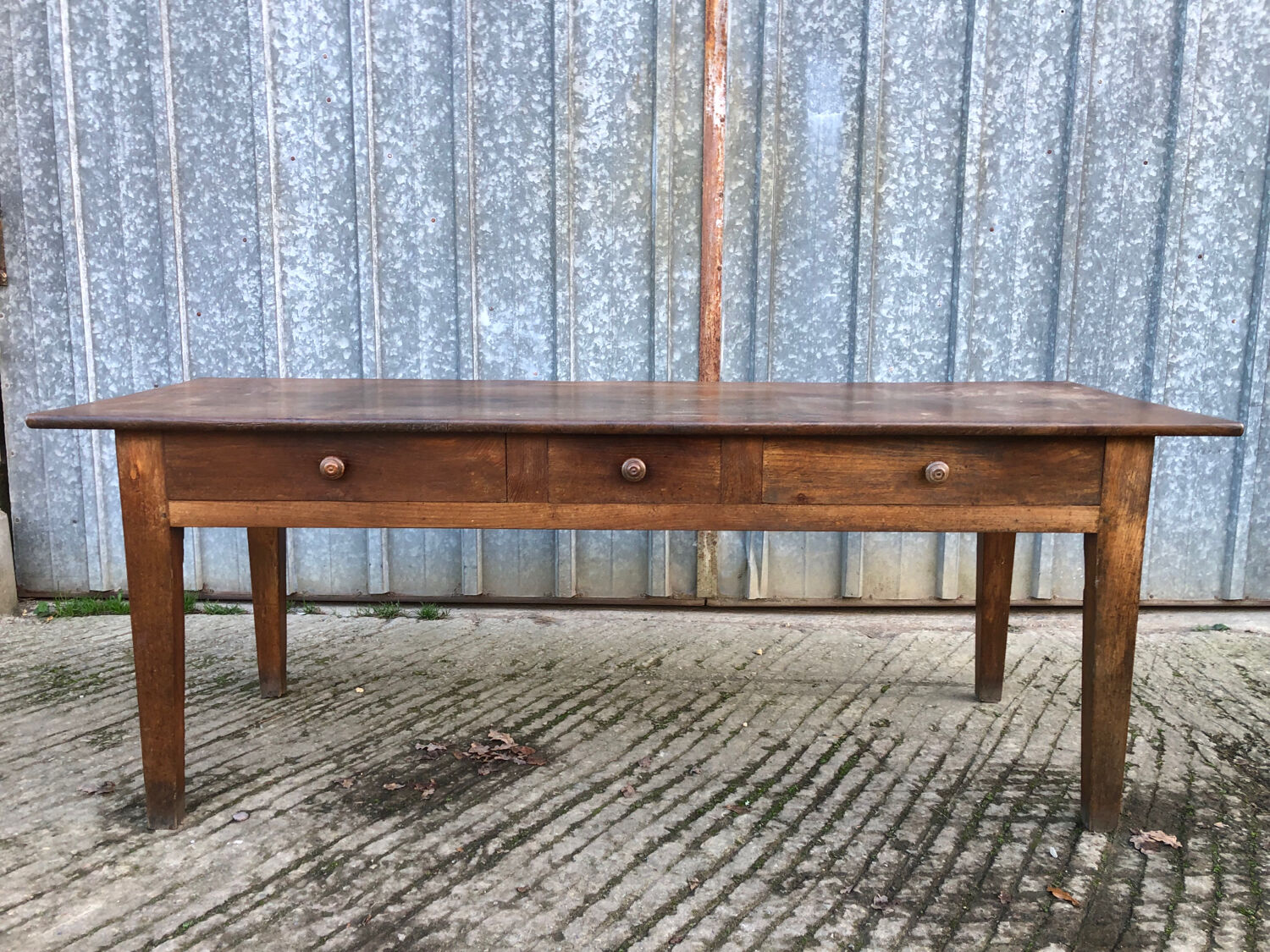 Antique chestnut farmhouse table with 3 drawers on the front.
