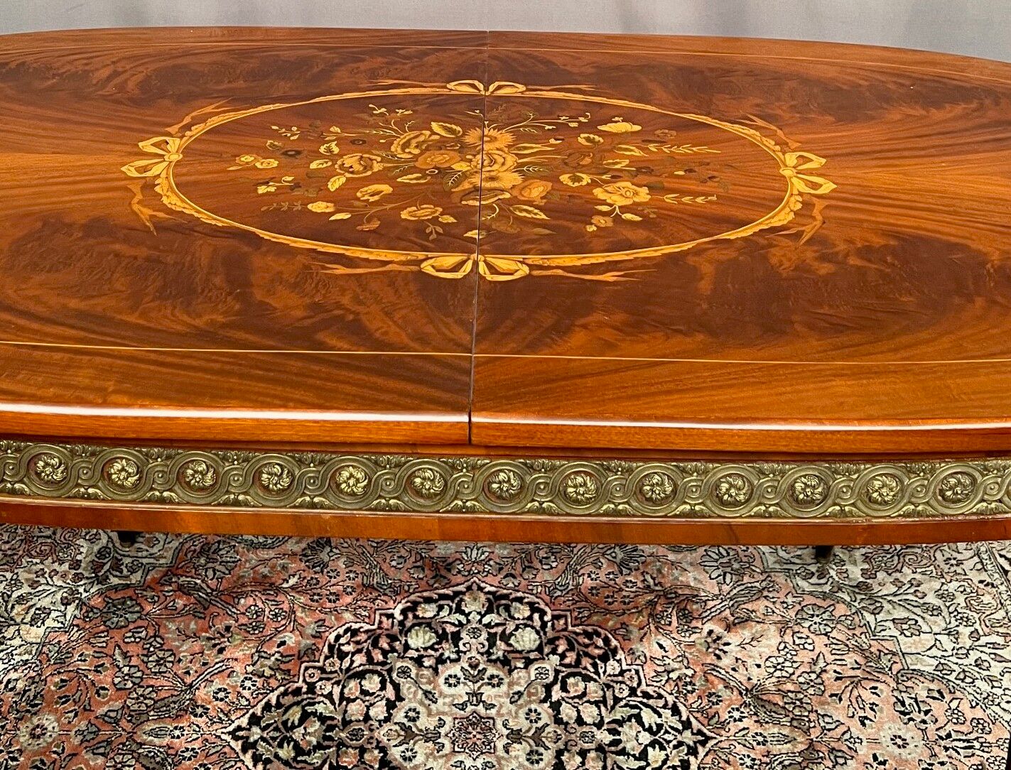 Louis XVI style oval dining table with rosewood marquetry extension mounted in bronze
