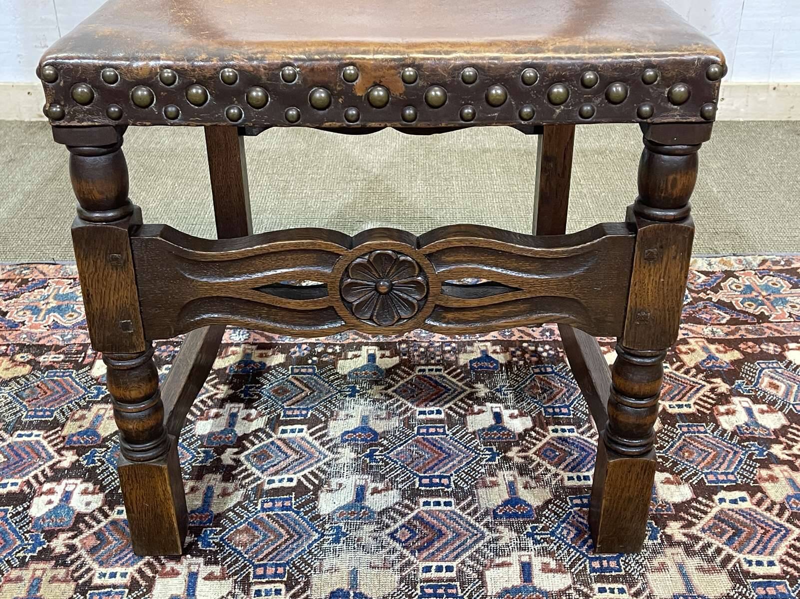High-backed chair from the early 20th century in oak and leather