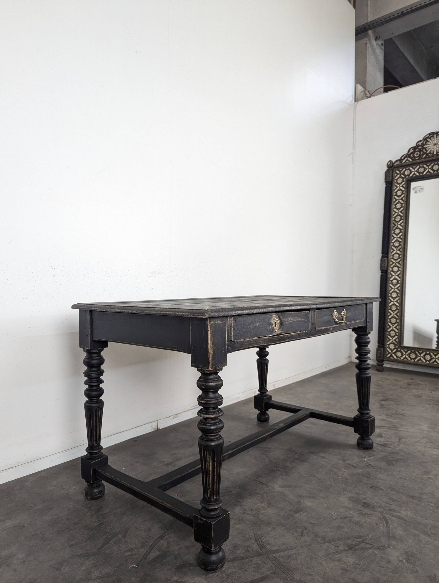 Louis XIII style desk in blackened wood with turned legs and two drawers.