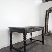 Louis XIII style desk in blackened wood with turned legs and two drawers.