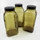 3 molded amber glass pharmacy bottles • Bakelite stoppers • 1950
