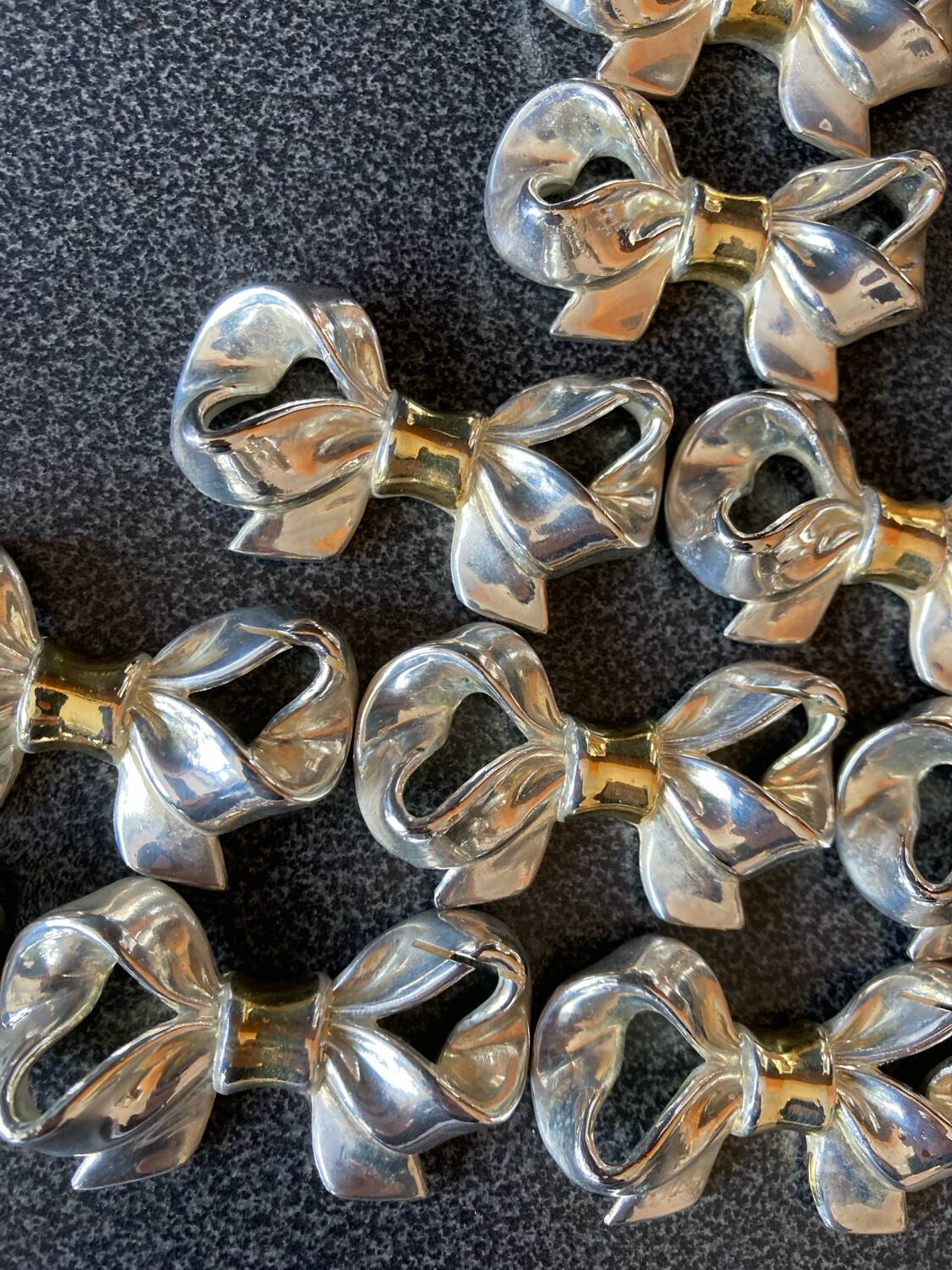 Name holders with bows in silver metal