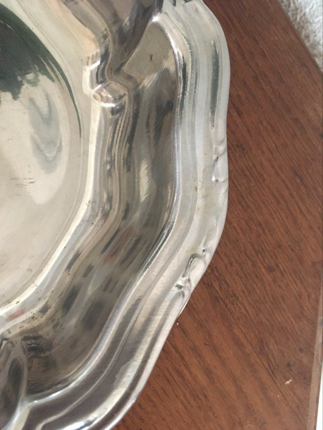 Two matching round dishes in stainless steel