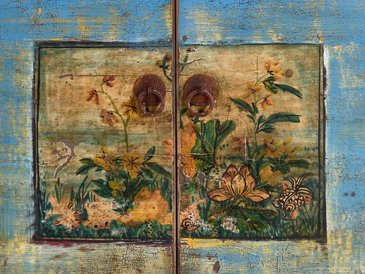 Old wooden entrance buffet in blue and yellow tones (circa 1920).