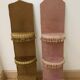 Two very kitsch wall shelves in bronze and pink velvet