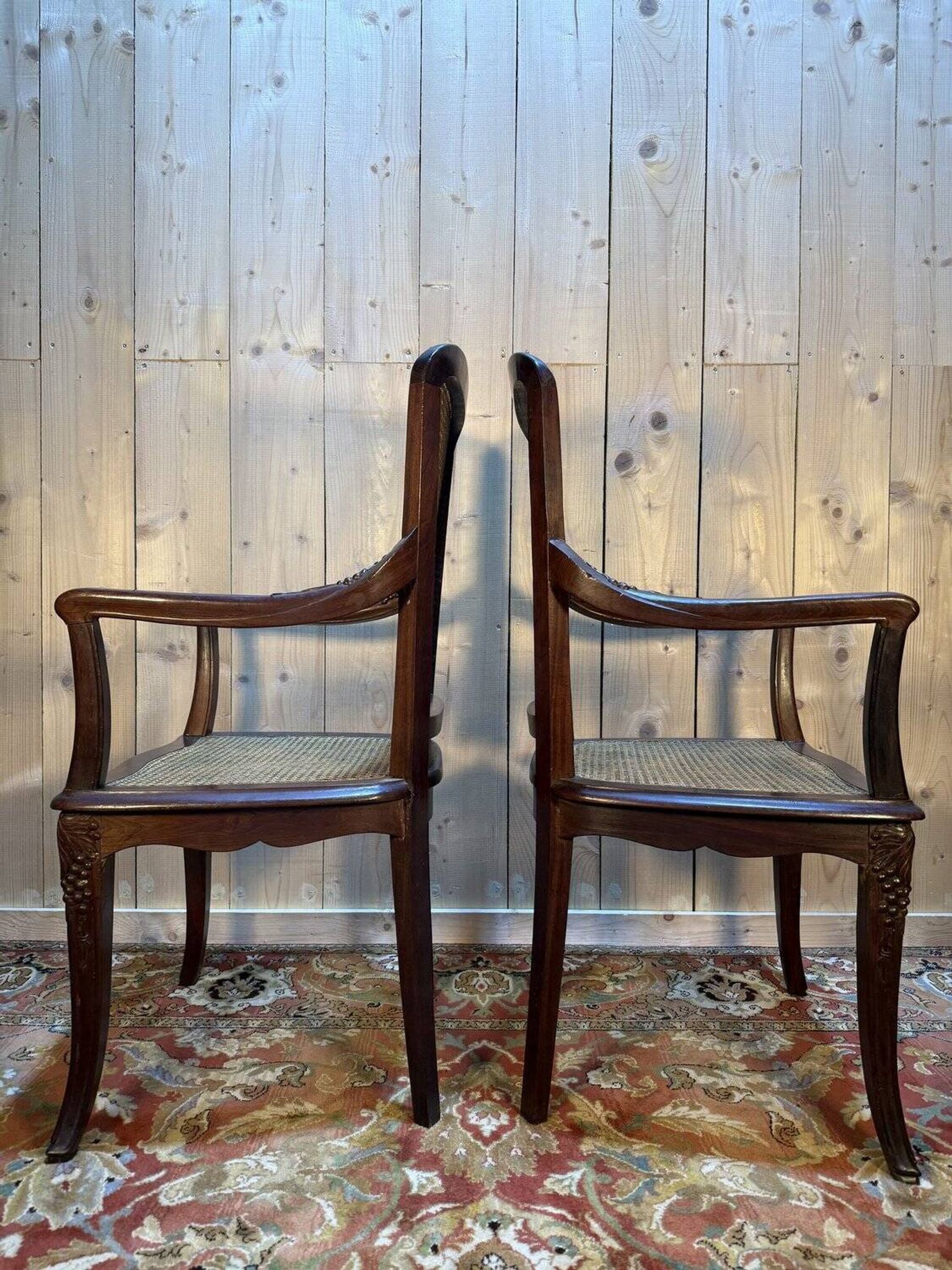 Pair of wide caned armchairs from the Art Nouveau period.